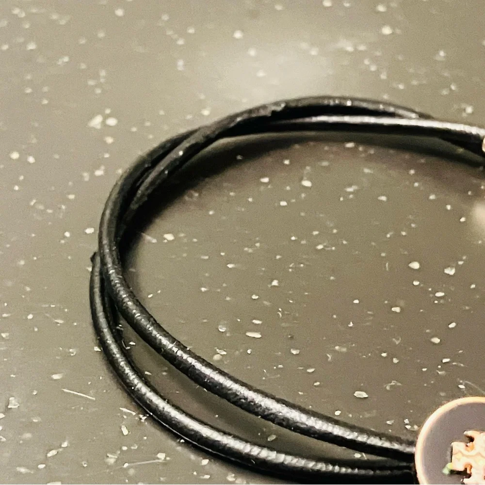 Tory Burch-Kira Double Leather Slider Bracelet in Black and Gold. Shows min wear
